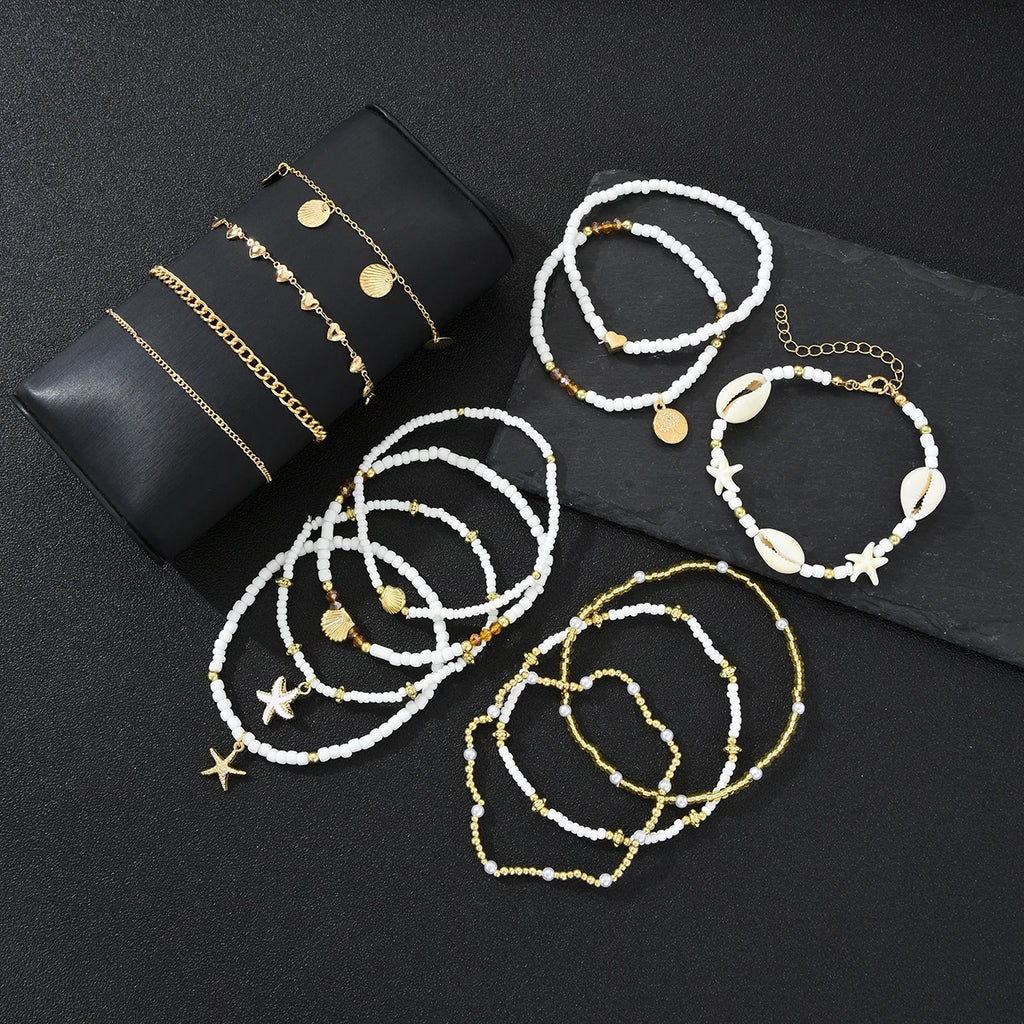 SHELLA - 
14Pcs/Set Bohemian Rice Beads Starfish Shell Anklet Sets for Women Retro Gold Color Multilayer Foot Chain Vacation Jewelry Gifts